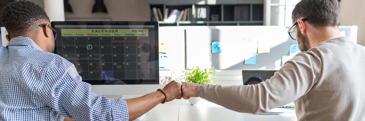 Addressing Neurodiversity Communication Barriers in the Workplace First bump between colleagues at work.
