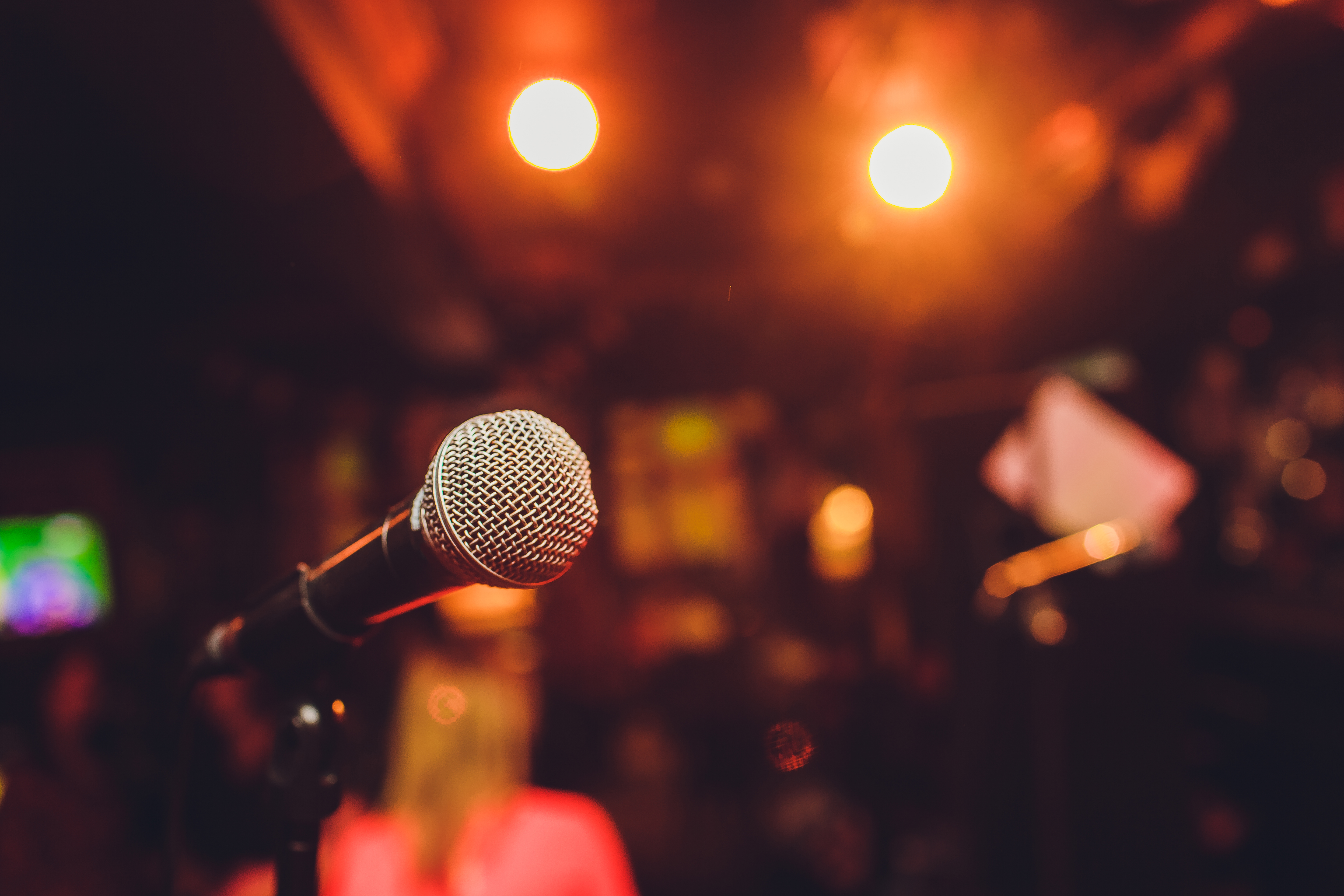 Microphone on stage against a background of auditorium.