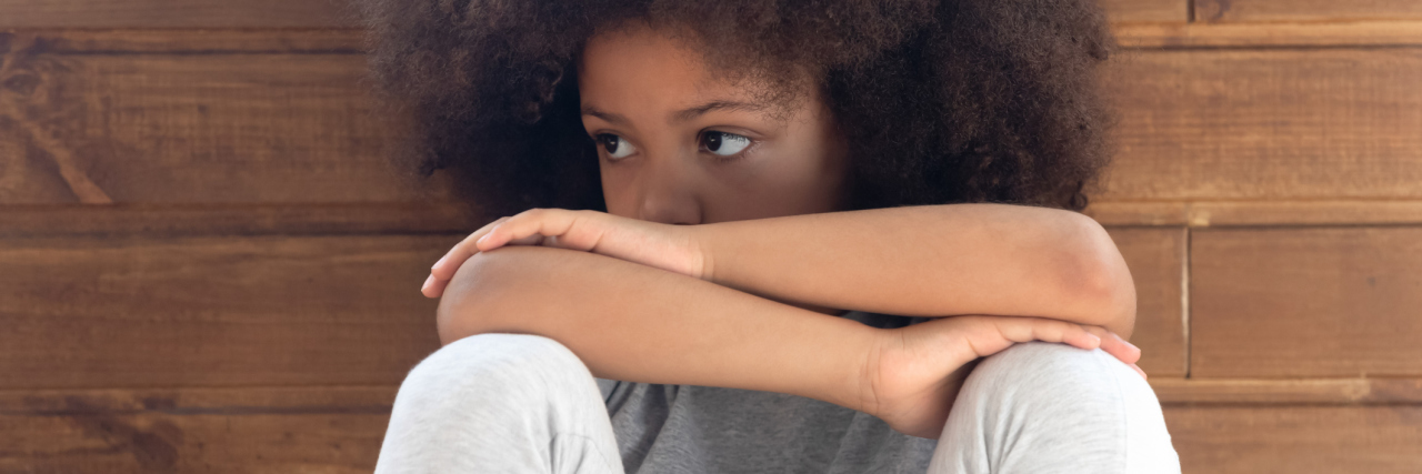Read This If You Struggle With Father's Day as a Child Abuse Survivor photo of upset little girl with arms crossed and leaning on her knees