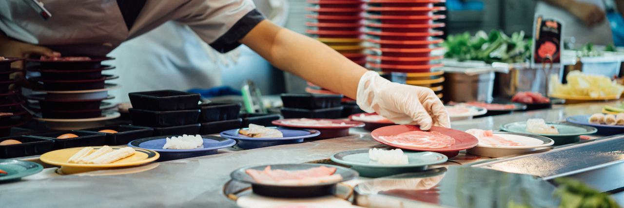How Bad Thoughts Are Like Bad Sushi A chef putting a place down on conveyor belt sushi