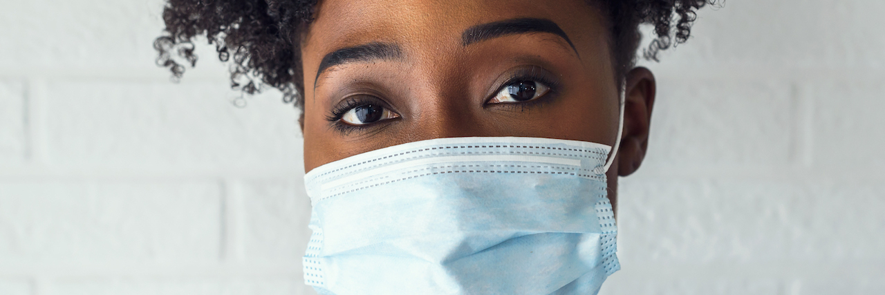 How Racism Affects Health Care and Outcomes for Black People Portrait of young African-American woman wearing disposable medical face mask