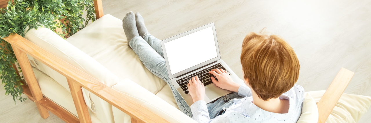 Socialization Struggles During COVID-19 as a Person With Autism Teenager using laptop computer.