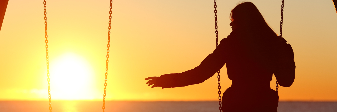Losing a Friend After a Multiple Sclerosis Diagnosis Woman on swing set reaching towards empty swing.