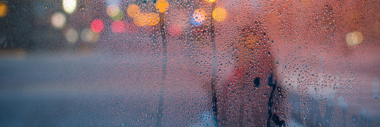 blurred image of woman outside in rain