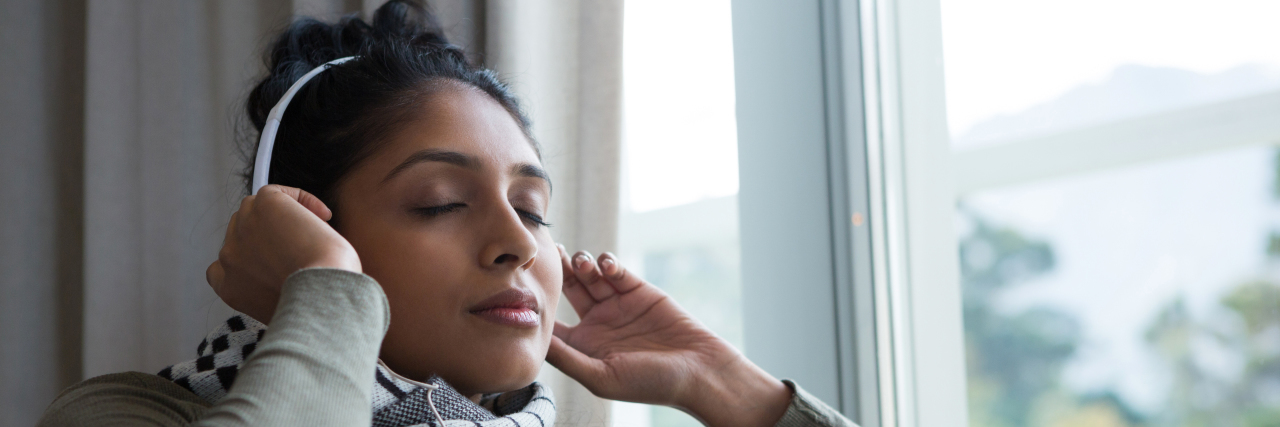 Woman listening to audiobook.