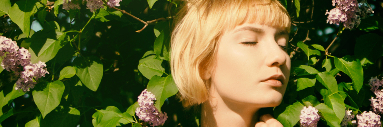 Managing My Epilepsy During the COVID-19 Crisis Woman in a lilac garden.