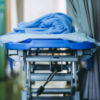 a blanket is place on top of a hospital stretcher