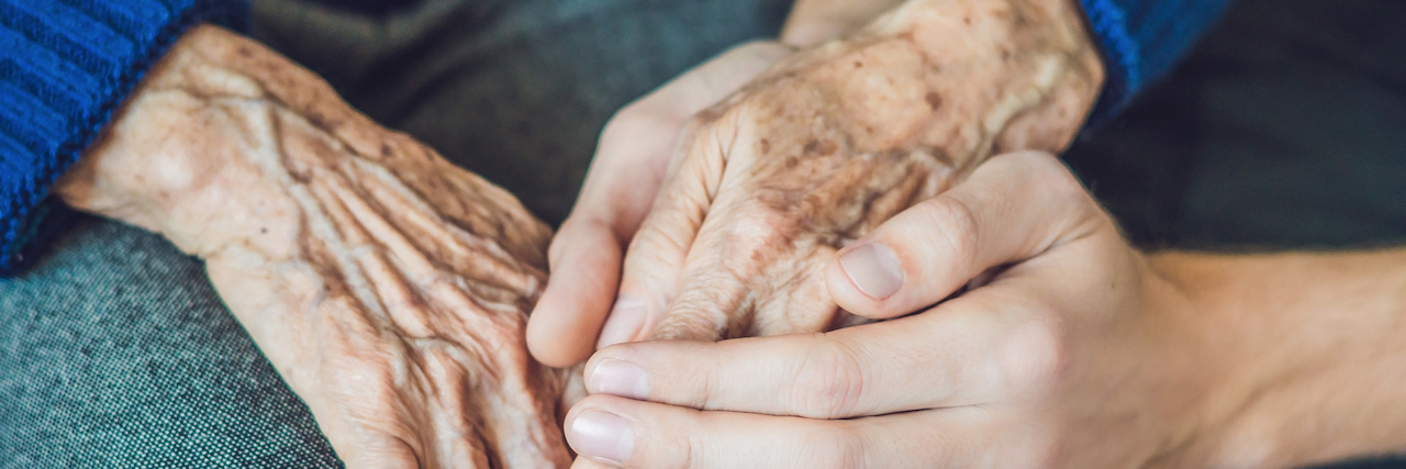 What Happens When Your Loved One Is in Hospice Care Hands of an old woman and a young man.