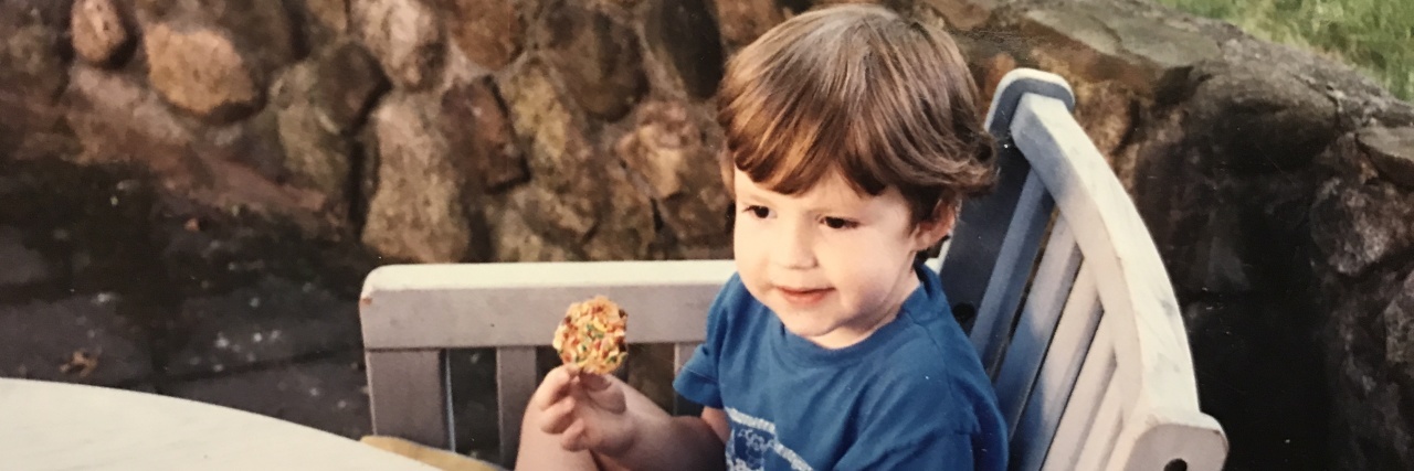 10 Things That Helped Me With Meltdowns as an Autistic Child Kerry as a small child sitting in a chair outdoors.