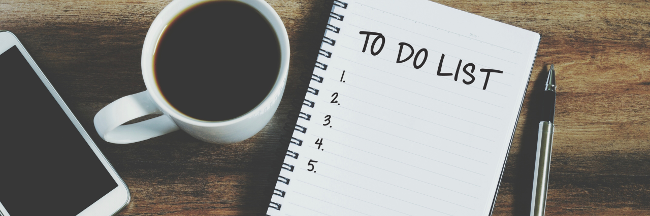 Learning to Set Priorities in My Life With Chronic Illness A white mug of black coffee, a note pad with 'To Do' written on the page and a pen