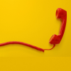 a red phone against a yellow background