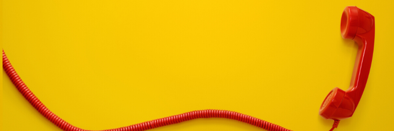 Support Lines in Illinois to Get Mental Health Help a red phone against a yellow background