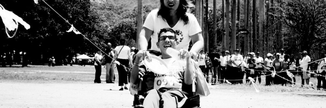 4 Tips for Volunteers Who Work With People With Disabilities mom pushes a son with cerebral palsy in a wheelchair