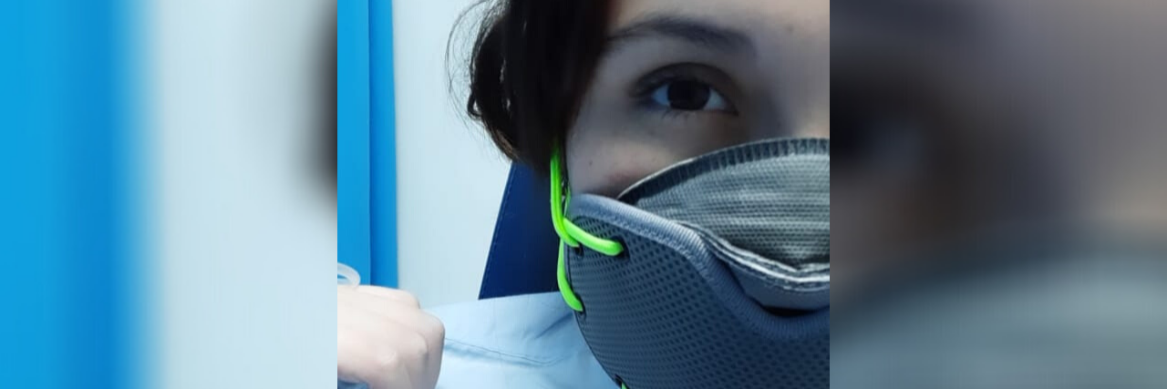 What the Aftermath of a Mild COVID-19 Case Really Looks Like photo of woman wearing respirator face mask in hospital with coronavirus COVID-19