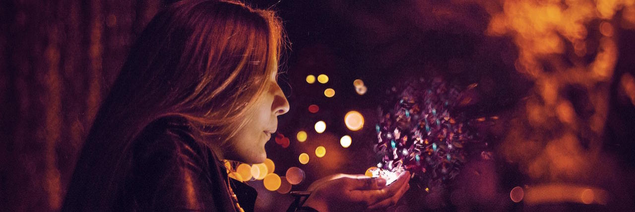 What 'Choosing Joy' Means As Someone with Mental Illness Woman blowing sprinkles out of her hands