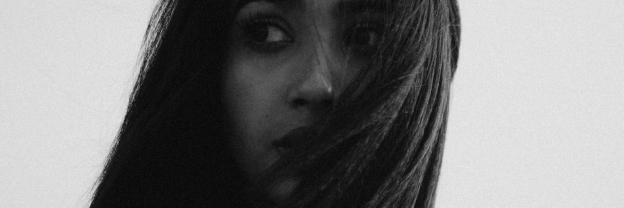 How COVID-19 Anxiety Affected Me as a Mental Health Professional black and white photo of woman looking over her shoulder in anxiety