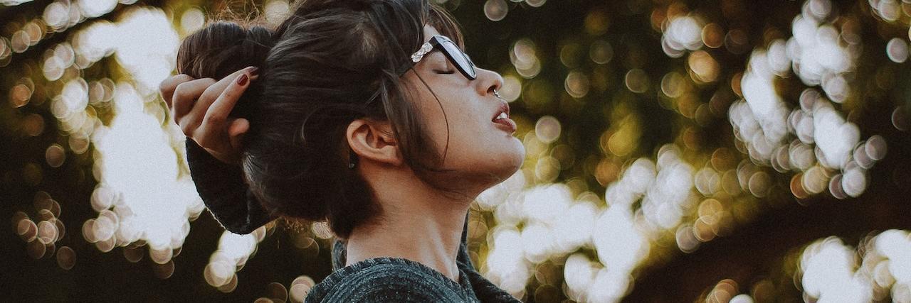 Complex PTSD: Healing After Repetitive Childhood Trauma A woman looking up at the trees