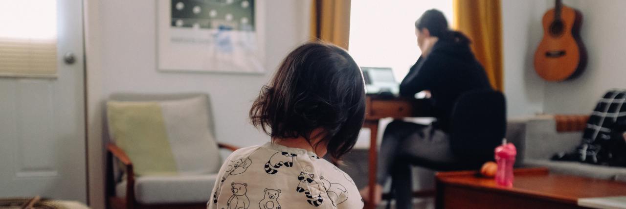Having Anxious Thoughts as a Mother During COVID-19 photo of woman in background with young child in foreground