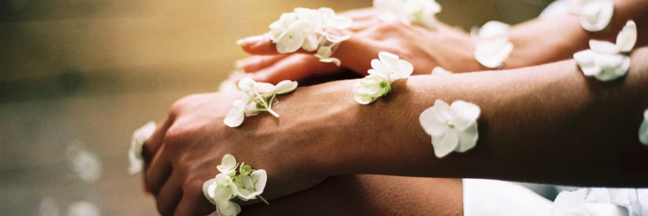 flowers blanketing someone's hands