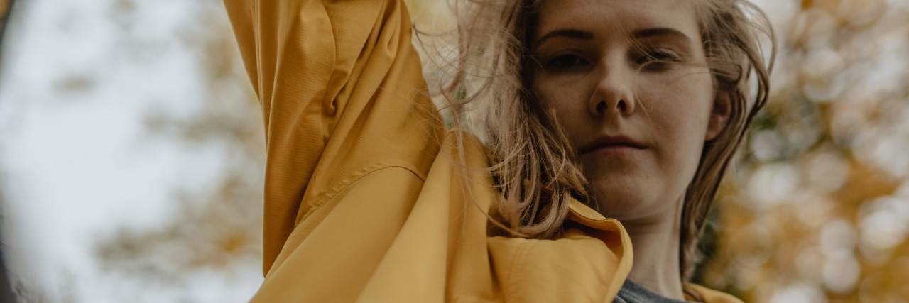 Should I Be Ashamed for Talking About My Emotions or Mental Illness? photo of woman taken from below, looking down into camera with serious expresson