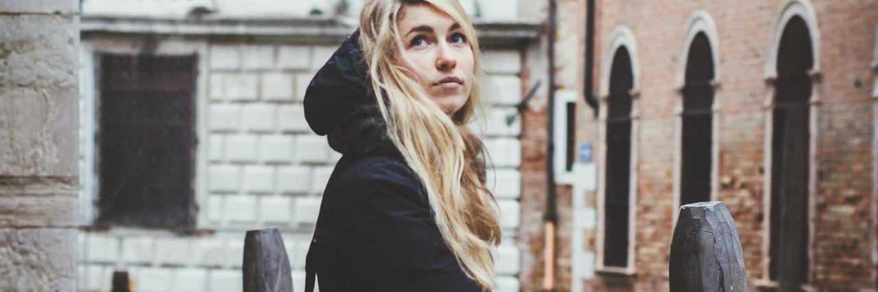 Am I Too Young to Talk About My Mental Health? photo of young woman standing among tall buildings