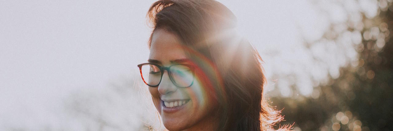 What OCD Taught Me About Myself Young woman wearing glasses and standing outside