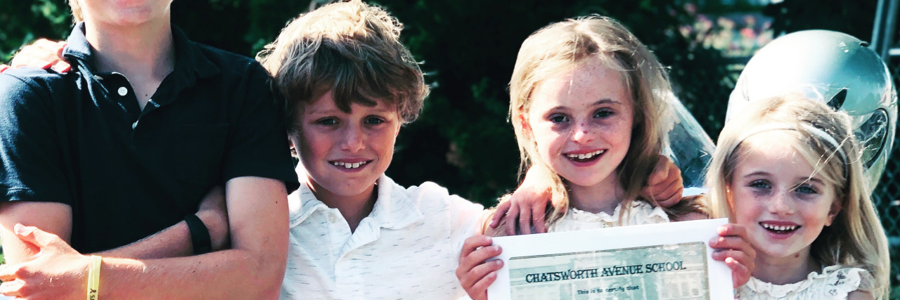 Celebrating My Child With Down Syndrome's Elementary School Graduation Ellie graduating from elementary school.