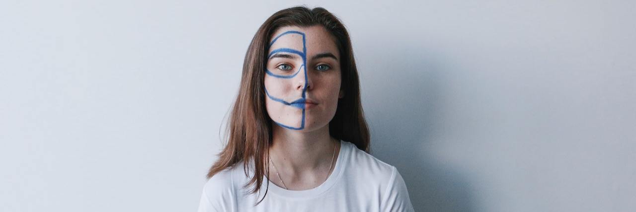A woman with blue paint on half her face
