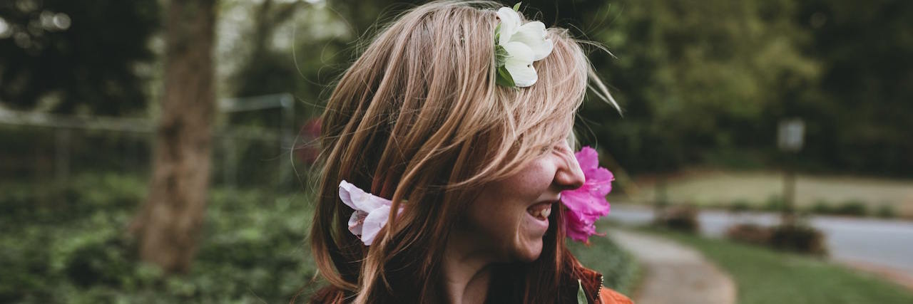 Physical, Emotional, Psychological and Spiritual Self-Care Categories Woman smiling with flowers in her hair