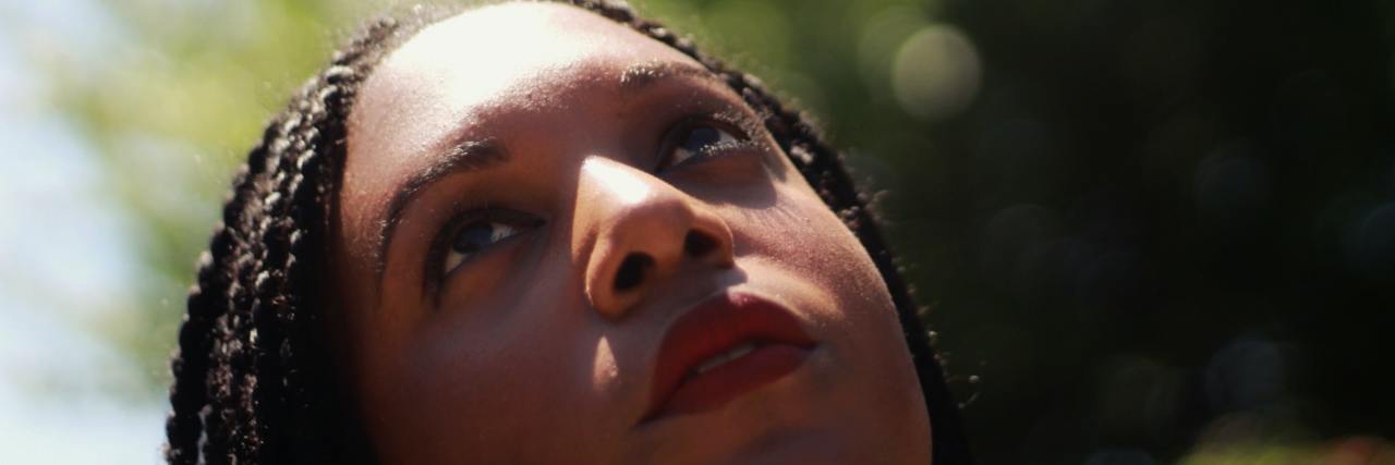 The Guilt of Choosing Your Health During Black Lives Matter Protests A woman looking up