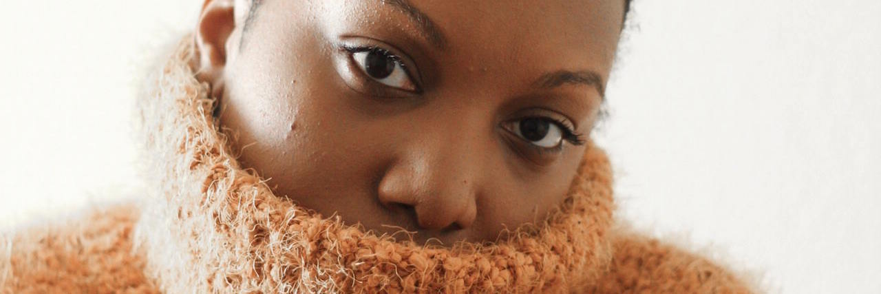 To People Who Judge Posting About Mental Health on Social Media A woman with a sweater over her face