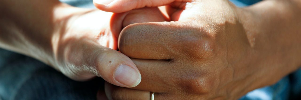 The Pressures Having a NICU Baby Will Put On a Couple two hands holding one another