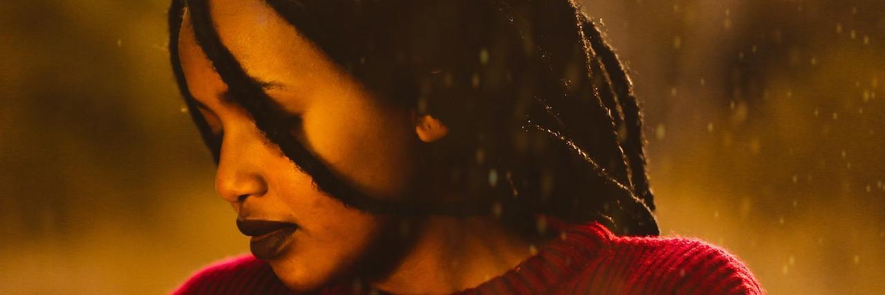 Study Suggests Higher Domestic Violence Risk for Disabled People Side profile of a black woman with locks in a red sweater