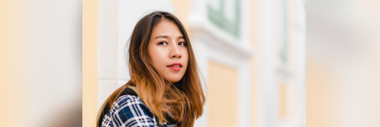 Discovering Life's Passions on My Mental Health Journey Young woman of color in front of a yellow building