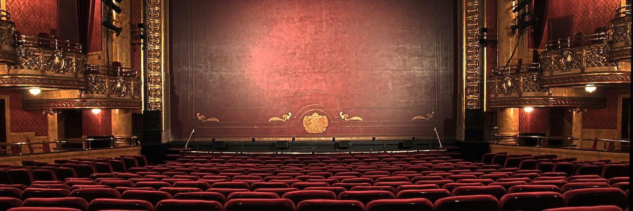 U.K.'s Flute Theater Adapts Shakespeare's 'Pericles' for Autistic Kids Empty theater taken from the back of the house, so you can see rows of red chairs and the stage