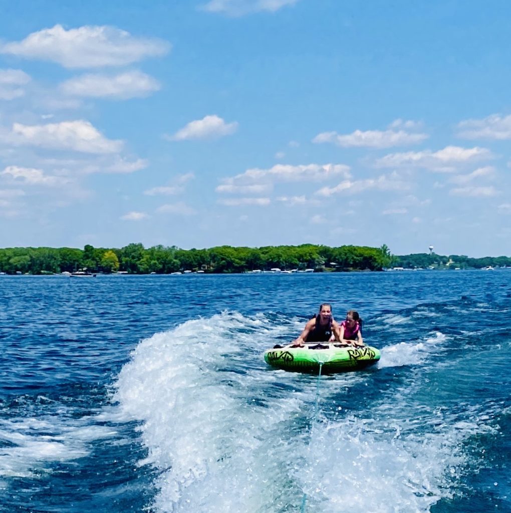 photo of contributor and her daughter on a tube in a lake