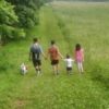 Heather's family walking in a field.
