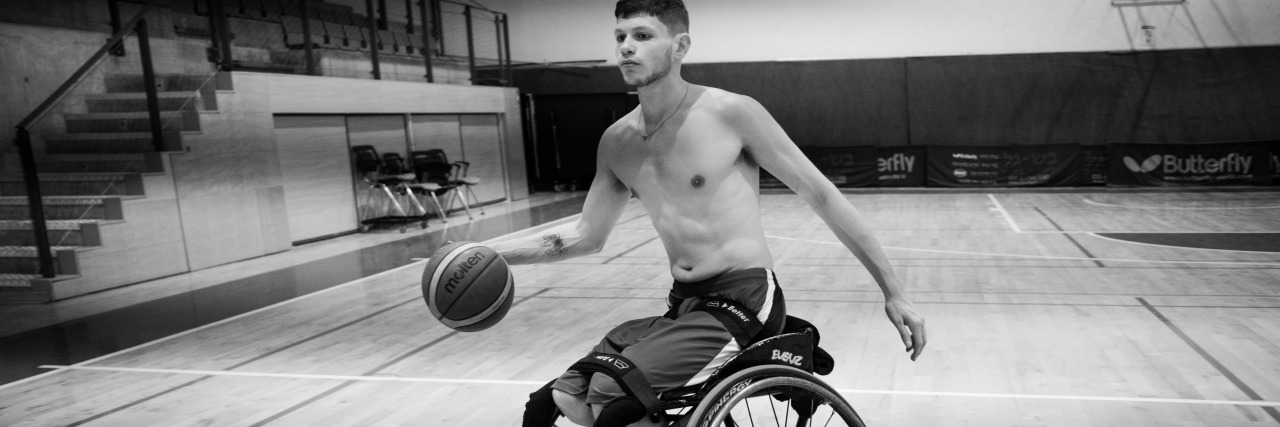 Amit playing wheelchair basketball.