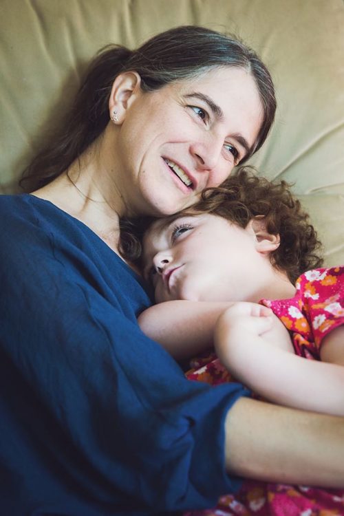 Anouk holding Lhassa in her arms and smiling