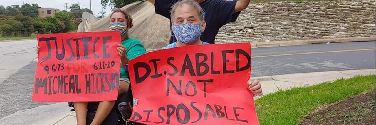 Disabled protesters in Texas outside hospital with signs