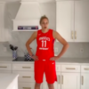 Elena Delle Donne in her red Mystics jersey in a kitchen