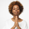 Black woman praying with eyes closed