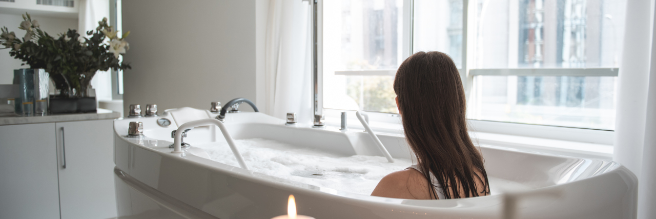 Why Self-Care Was Hard After My Bronchiectasis Diagnosis Woman relaxing in bathtub.