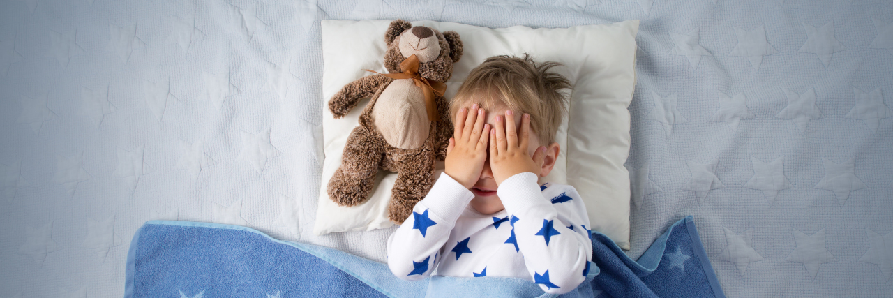 Helping Children on the Autism Spectrum Sleep Better Child in bed trying to sleep.