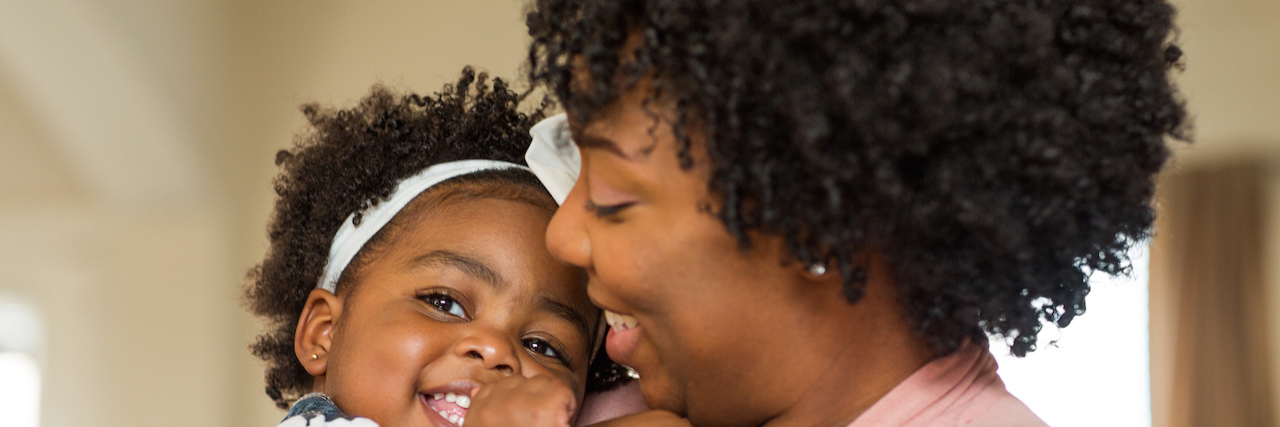 Supporting Parents With Complex PTSD From Childhood Sexual Trauma Black mother and daughter smiling at home.