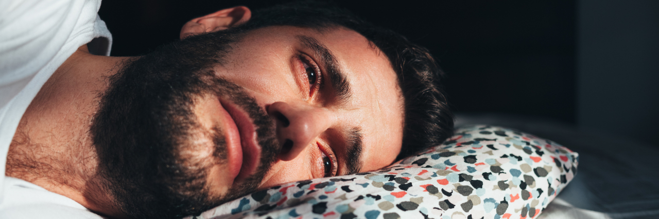 What Is Unipolar Depression Young depressed man crying in bed