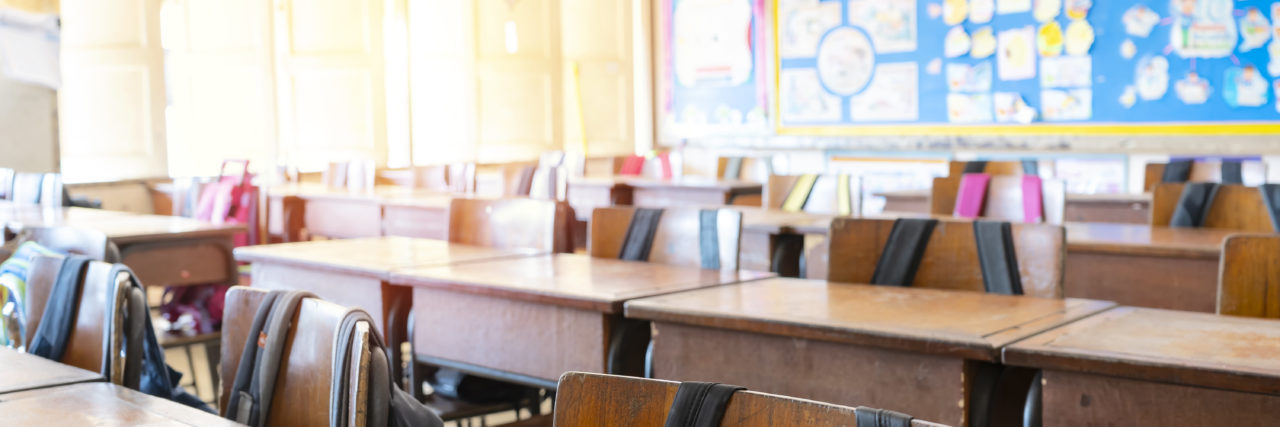 Going to School With Undiagnosed Autism Empty school classroom with sunlight streaming in.