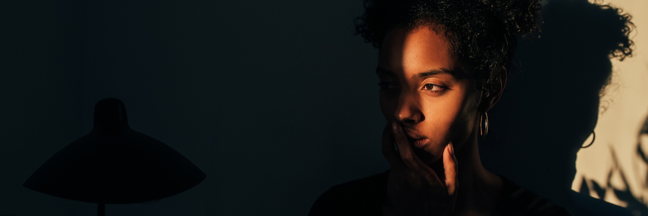 New Study Highlights Mental Health Impact of Autistic Masking Stylish young woman standing near a plant with shadow light