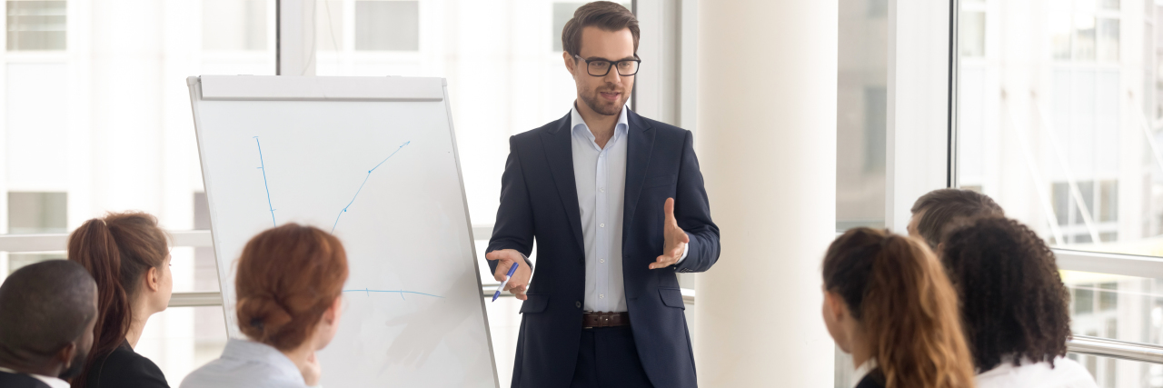 Stuttering Out Loud in the Workplace Man giving a presentation at work.