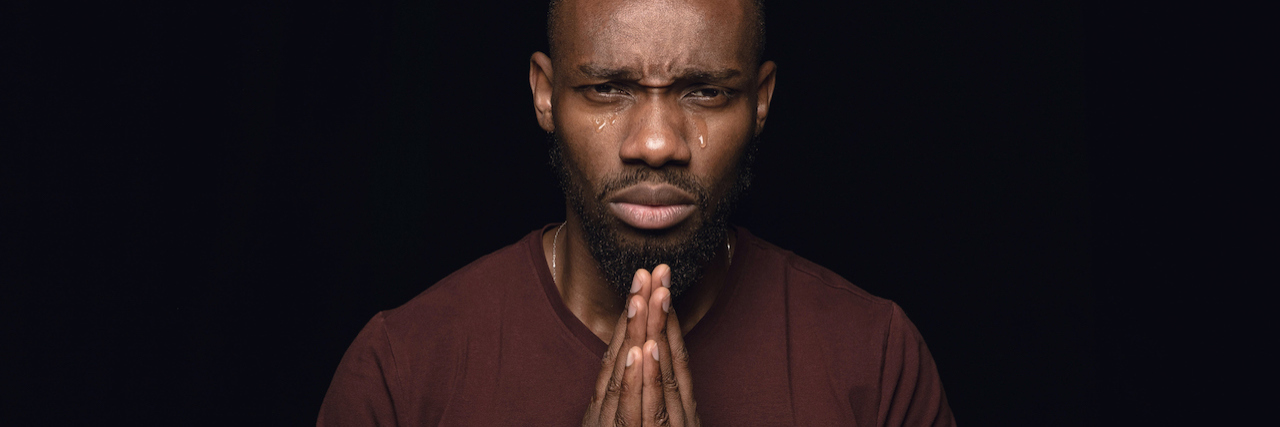 Kanye West and Mental Health in the Black Community A man holding his hands in prayer
